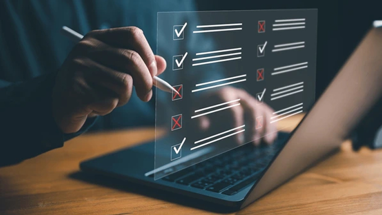 Person working on a checklist on a laptop