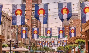 Flags Hanging from above in Larimer Square