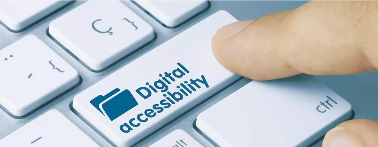Image of a finger pressing a computer key called digital accessibility. 